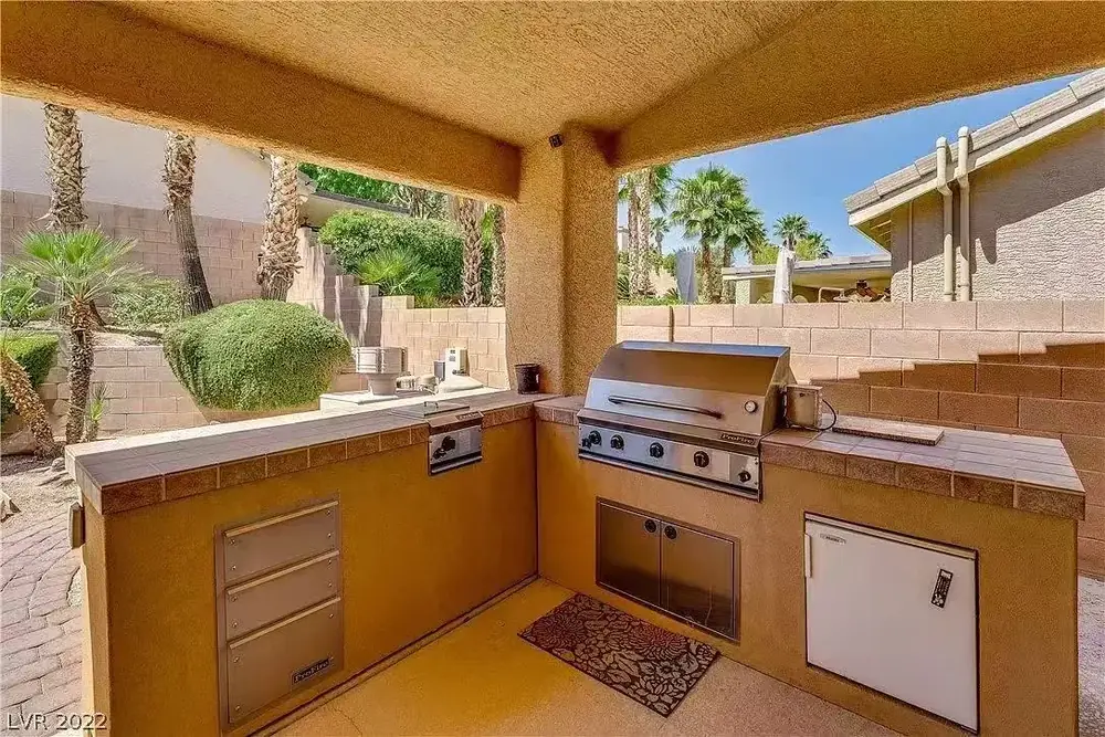 The covered outdoor patio with a built-in barbecue at Caring Angels Henderson