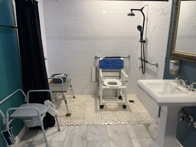 An accessible bathroom with a roll-in shower and grab bars